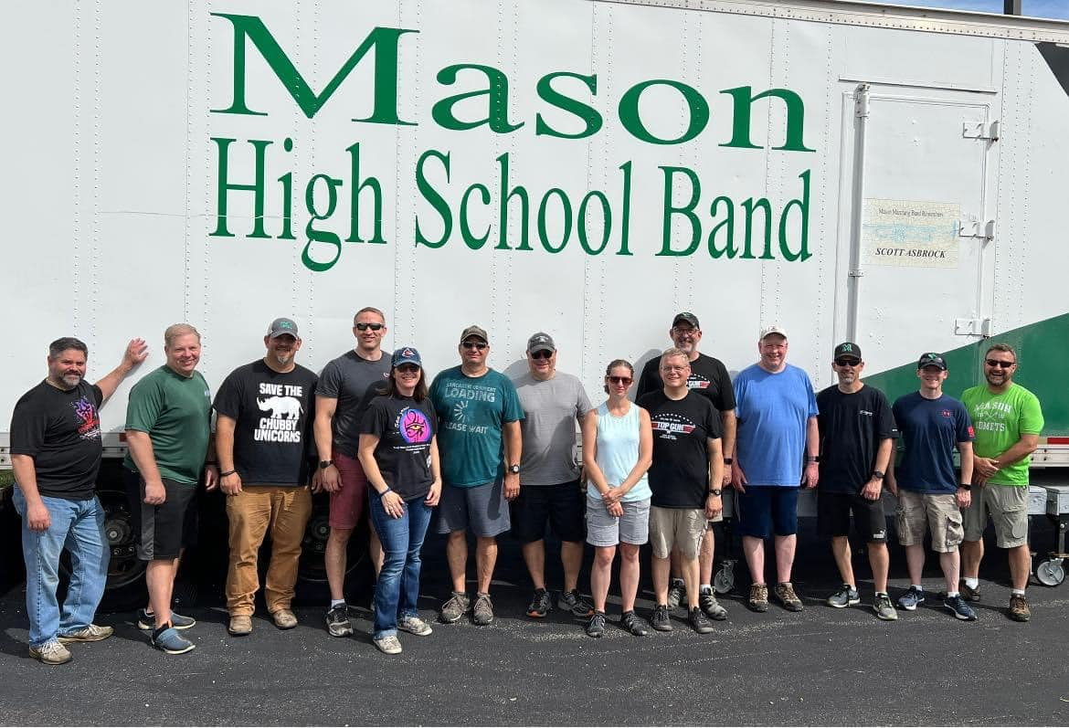 group in front of Mason High School Band trailer